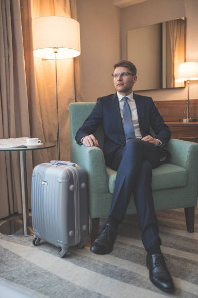 istock Young businessman with suitcase indoors 1094488092