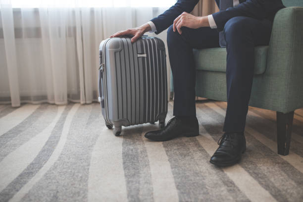 istock Young businessman with a suitcase indoors 1094488200