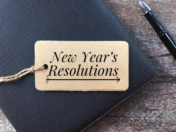 New Year resolutions concept. New Year’s Resolutions written on a paper tag. 2019 new year resolution stock pictures, royalty-free photos & images