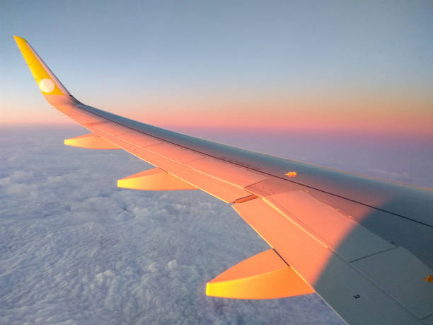 istock Airplane flying high above the clouds at sunset. Nature background. 1094490300