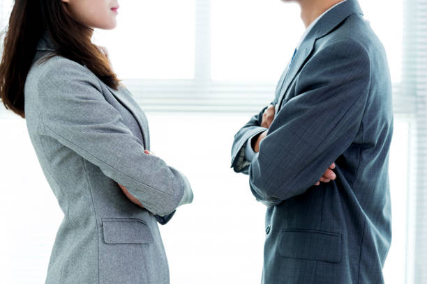 istock Two businesspeople standing face to face 1094493640