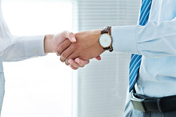 istock Businesspeople handshake indoors 1094493676