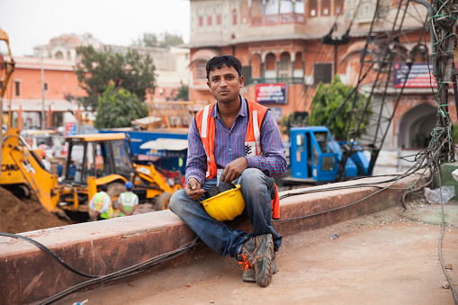 Men working and taking a rest at the station in Jaipur, India