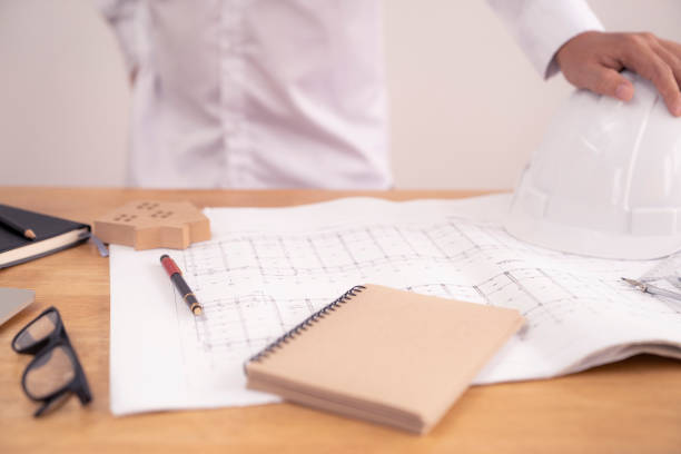 istock architect or civil engineer during drawing home or building in office on working table with office stationary , laptop ,color pallette sampling. 1094493926