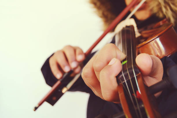 istock Horizontal shot of a boy playing the stringed and bowed musical instrument, the violin, captured from the front 1094496784
