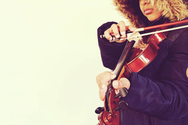 istock A boy playing the stringed and bowed musical instrument, the violin 1094496786