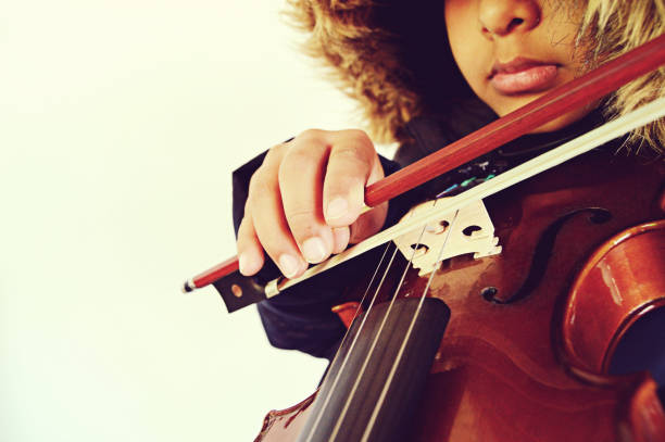 istock A boy playing the stringed and bowed musical instrument, the violin 1094496788