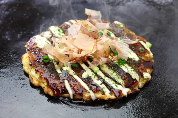 Okonomiyaki is a Japanese savory pancake containing a variety of ingredients.