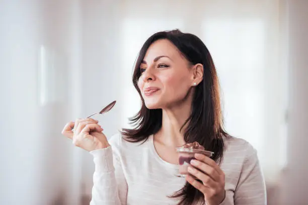 Gorgeous brunette enjoying dessert.