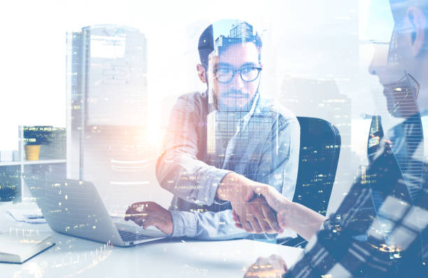 istock Businessmen shaking hands in office, city 1094500660