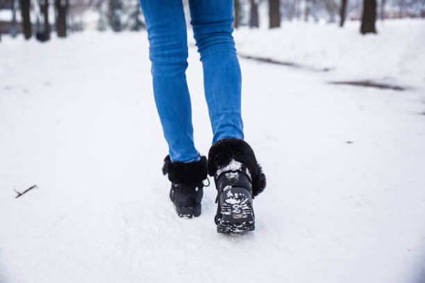 istock Woman feet walking through snow 1094500774