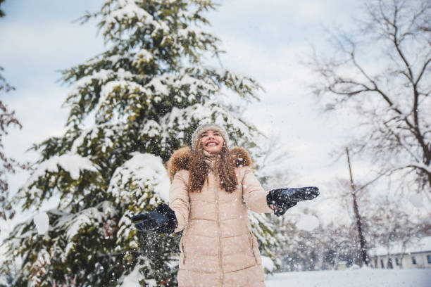 istock woman throwing snow in the air 1094501106