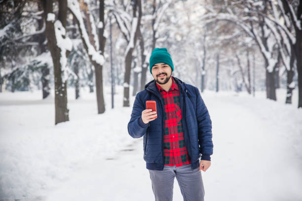 istock Man with smart phone winter park 1094503890