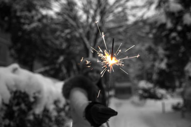 Happy girl holding burning sparklers