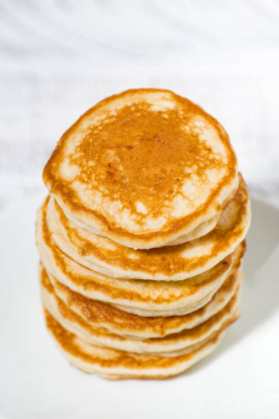 istock stack of delicious pancakes on a plate, vertical top view 1094505036