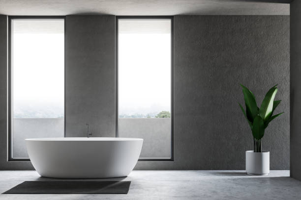 istock Gray loft bathroom interior with white tub 1094505250