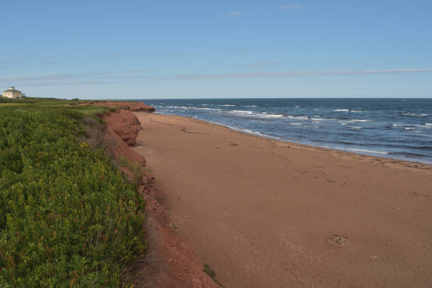 Sculptured red rocks, shaped by the tides of the Atlantic Ocean at Thunder Cove Beach, Darnley, Prince Edward Island, Canada.