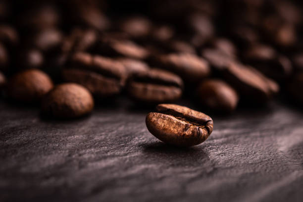 Coffee beans on a dark slate stock photo