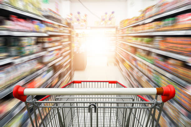 istock Supermarket aisle with empty red shopping cart 1094507402