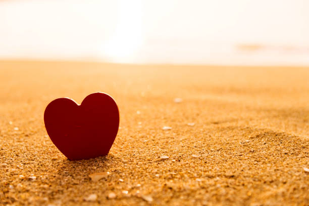 istock Red heart shape on the golden beach 1094509232