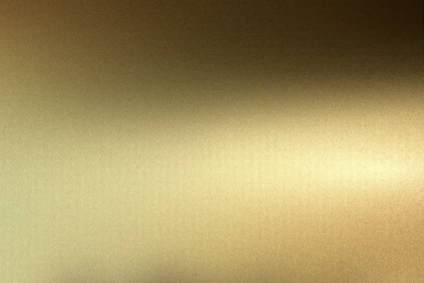 istock Light shining on rough dark gold steel plate texture, abstract background 1094509296