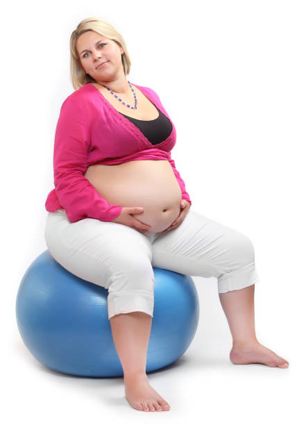 istock Overweight woman siting on a blue ball. 1094522016