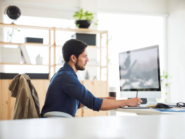 istock Millennial man working in front of the computer 1094522994