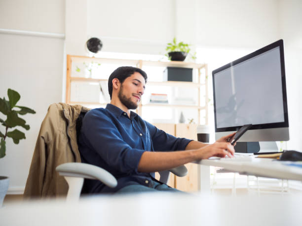 istock Millennial man in his office with a tablet 1094523008