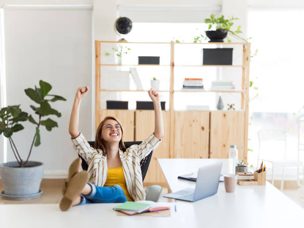 istock Young business woman celebrating at work 1094523046