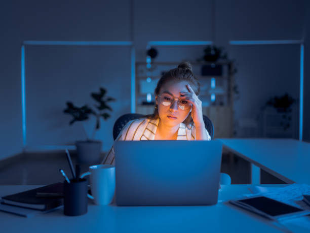 Young woman working late in office