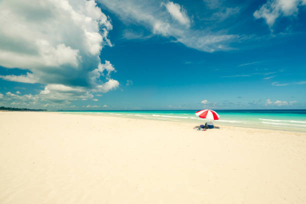 istock red umbrella on the Caribbean beach 1094524836