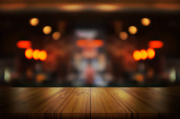 istock Empty wooden table top with blurred coffee shop or restaurant interior background. Abstract background can be used product display. 1094530056