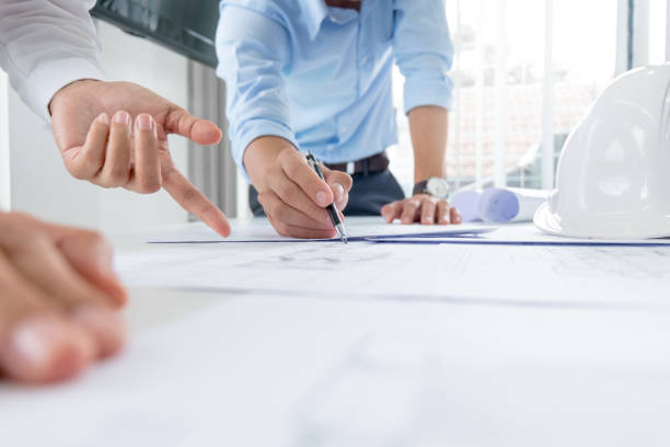 istock Close up of engineer hands discussing a building construction project at workplace 1094530494