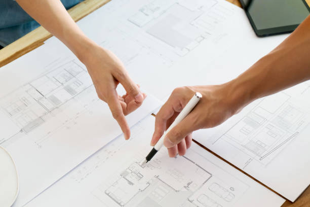 istock Close up of engineer hands discussing a building construction project at workplace 1094530542