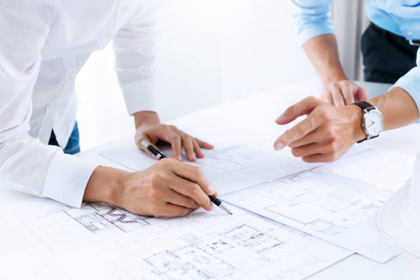 istock Close up of engineer hands discussing a building construction project at workplace 1094530580