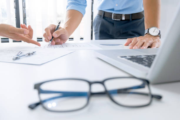 istock Close up of engineer hands discussing a building construction project at workplace 1094530766