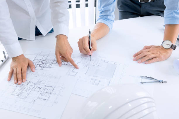 istock Close up of engineer hands discussing a building construction project at workplace 1094530774
