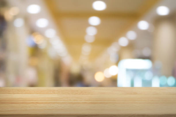 istock wooden table with montage blurred shopping mall background 1094530776