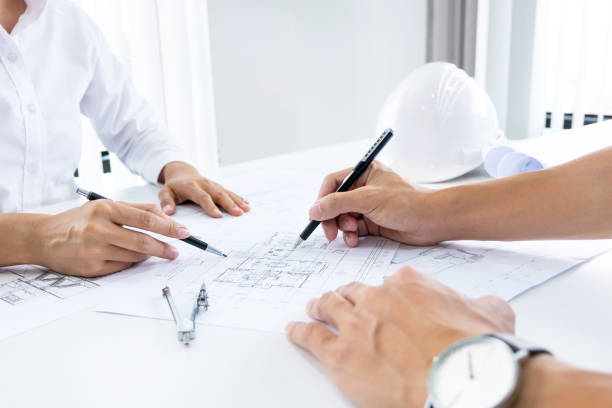 istock Close up of engineer hands discussing a building construction project at workplace 1094530790