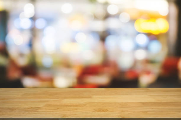 istock wooden table top in front of blur restaurant background 1094530818