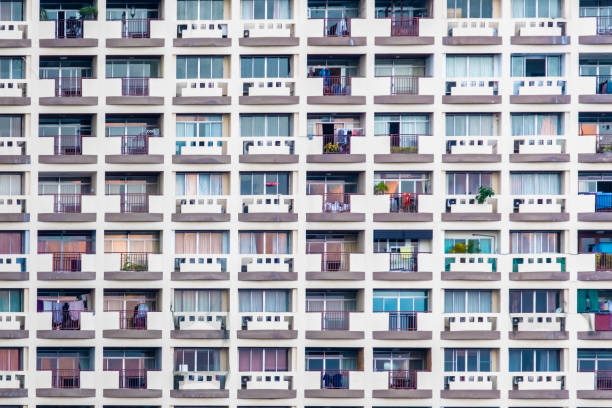 istock Front view of apartment building background. The windows office building for background. Condominium or apartment building with asymmetrical, stair-step architecture in the Bangkok city 1094534396