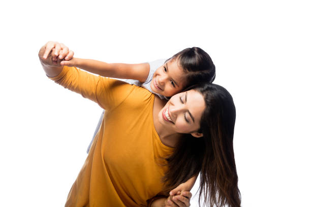 Playful toddler and mother in white background