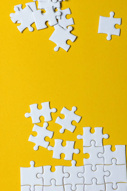 istock Jigsaw puzzles placed on a yellow background Creative concept with copy space 1094537346