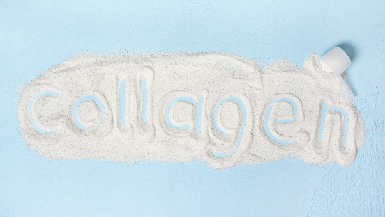 blue background with collagen powder close up