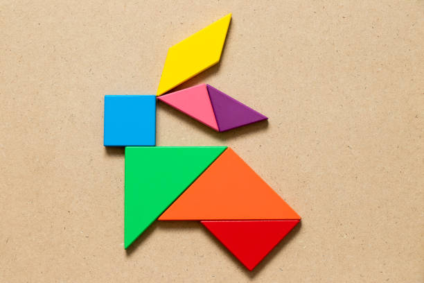 istock Color tangram puzzle in rabbit shape on wood background 1094539634