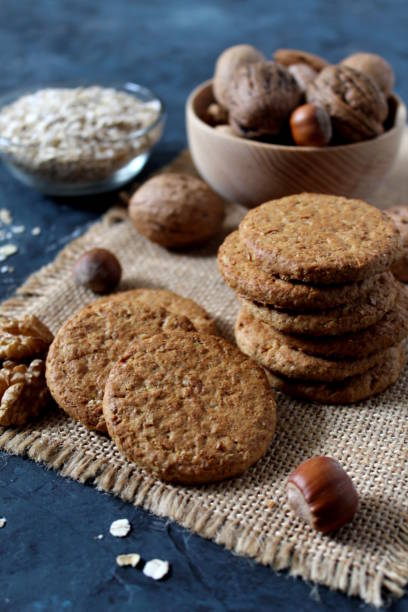 istock Sweet biscuit barley, oats and walnuts on the dark background. 1094541644