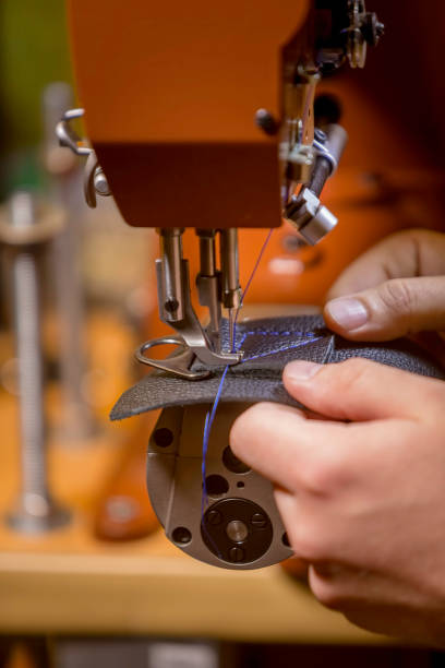 istock Vertical Shot of Sewing a Box Stitch on Black Leather 1094549744