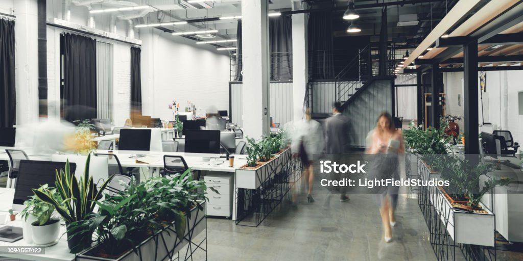 modern open space office interior with blurred business colleagues Office Stock Photo