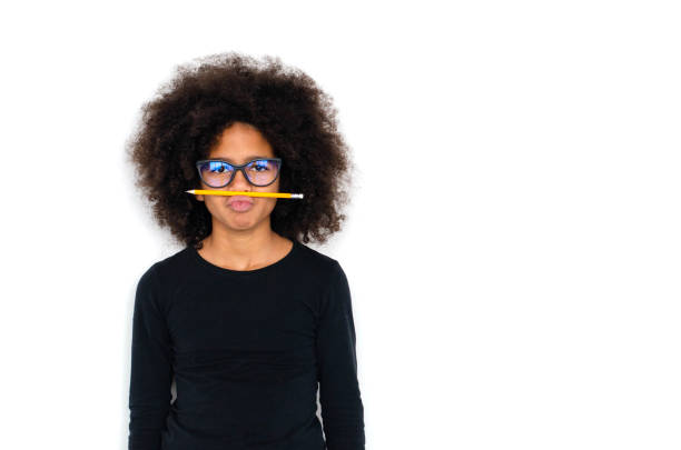 istock Dark-skinned girl funny holding a simple pencil. 1094563440