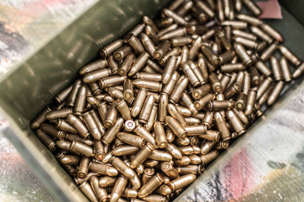Top view of box with ammunition for gun on the table. Bullets for pistol in shooting range